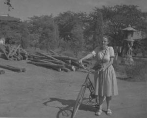 Photo of Chapin with her bicycle in China, ca.1930