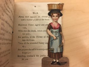 A paper doll is tucked inside the book, The History of Little Fanny, from the Ellery Yale Wood Collection in Special Collections.