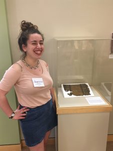 Rachel Grand (BMC '21) stands next to an Egyptian Byzantine textile on view in the exhibition ReconTEXTILEize (Spring 2019).